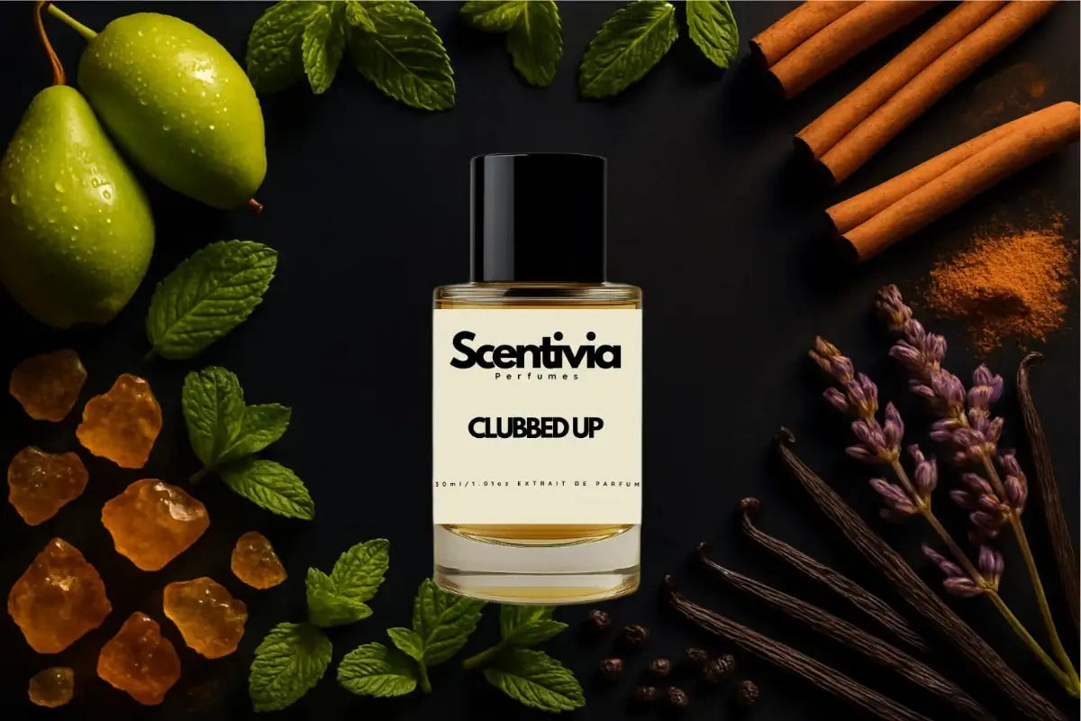 Scentivia Clubbed Up perfume bottle arranged flat on a black surface surrounded by whole green pears with water droplets, fresh mint leaves, cinnamon sticks, powdered cinnamon, lavender sprigs, vanilla beans, and golden resin pieces.