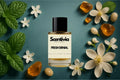 Scentivia Fresh Denial perfume bottle arranged flat on a teal surface surrounded by fresh green mint leaves, small white blossoms, unopened flower buds, golden amber pieces, and smooth light-colored pebbles.