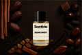 Scentivia Sugar Daddy perfume bottle surrounded by cinnamon sticks, dates, vanilla pods, amber-colored crystals, chocolate pralines, and tonka beans on a dark mahogany background.