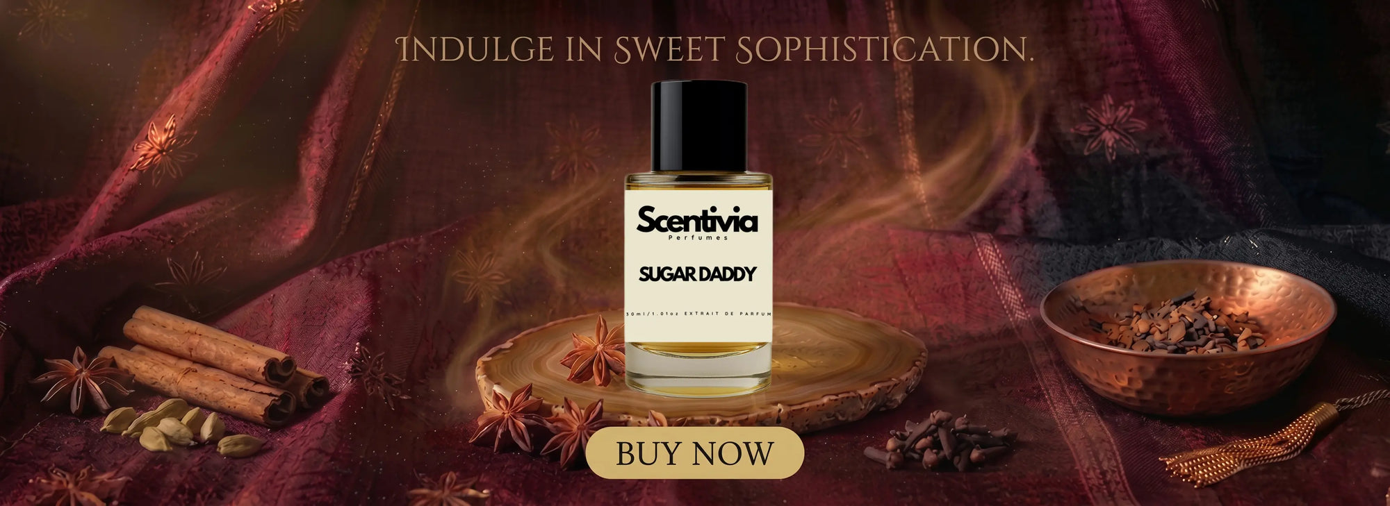 Scentivia Perfumes promotional banner for the "Sugar Daddy" fragrance with the tagline "Indulge in Sweet Sophistication," featuring the perfume bottle on a wooden slice surrounded by cinnamon, star anise, and a copper bowl.