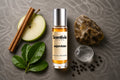 Aqua Rush Roll On bottle surrounded by Apple, Cinnamon, Citrus Leaves, Minerals and Pepper with fresh aquatic notes