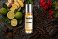 Hot Wired Roll On bottle surrounded by Ginger, Citrus, Red Florals, Incense and Oud Wood with smoky spicy notes