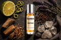 Raw Pulse roll on bottle with Bergamot, Lavender, Peppercorn, Oud wood and crystal stones on dark textured background