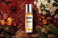 Red Haze roll on bottle with Saffron, Jasmine flowers, Oud wood, Amber crystals and Pine branches on deep red background