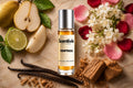 Temptress roll on bottle with Pear, Lime, Jasmine flowers, Rose petals, Vanilla pods and Sandalwood on marble background